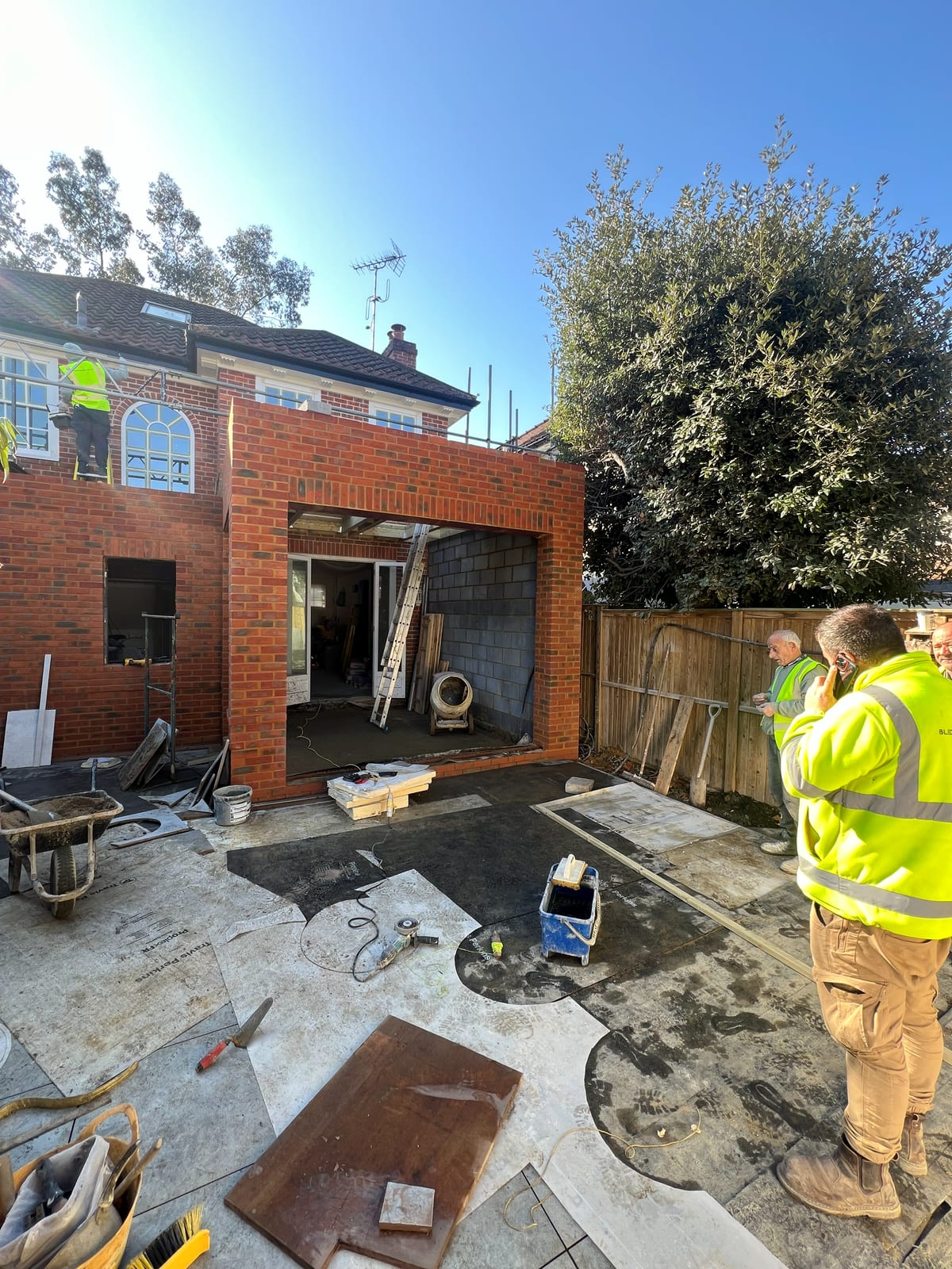 The rear extension under construction, brickwork and opening formed for the glazed doors, with the site team working