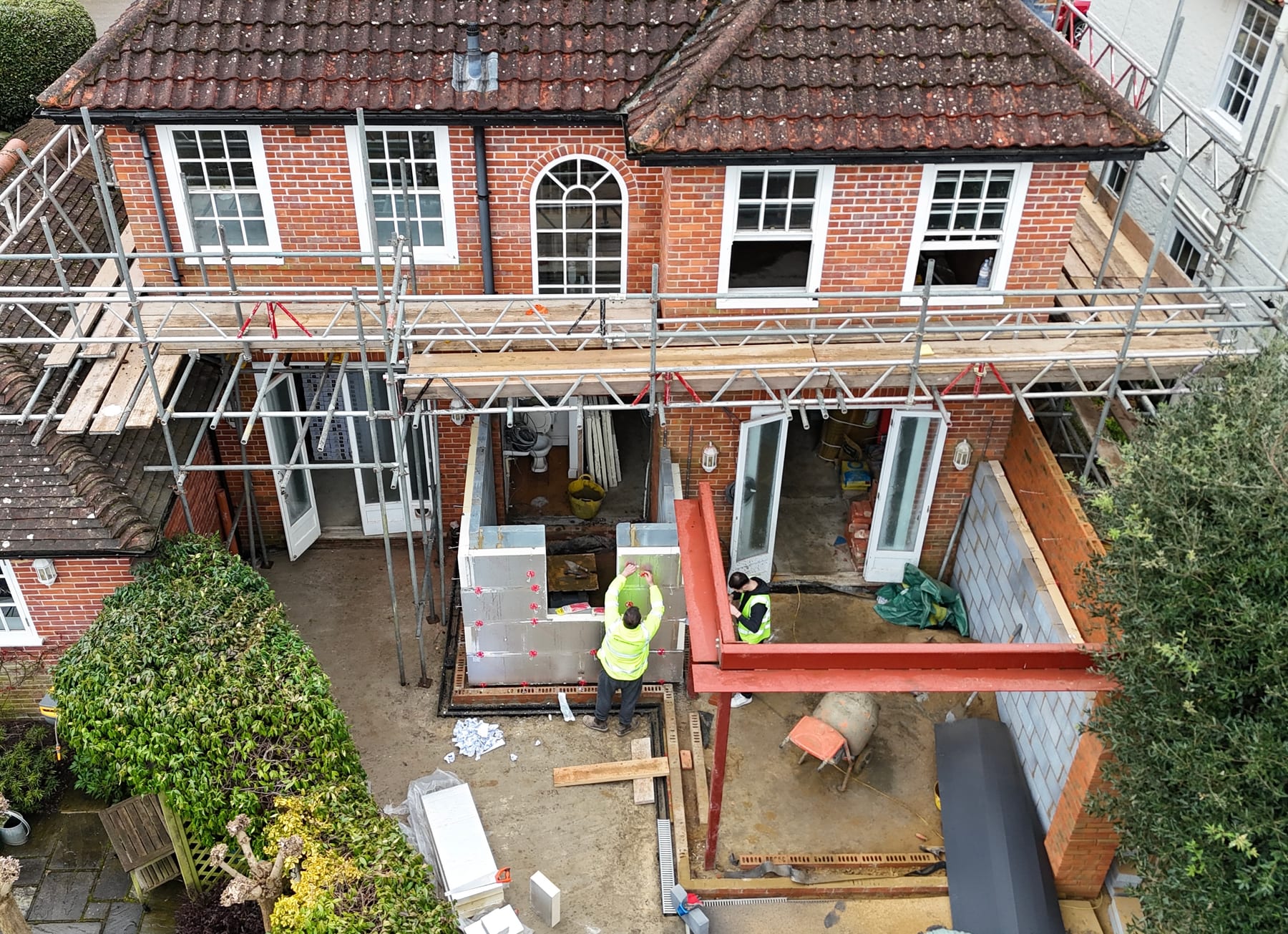 Aerial view of the rear extension under construction in Richmond upon Thames, showing the new painted structural steel beam spanning the opened-up ground floor