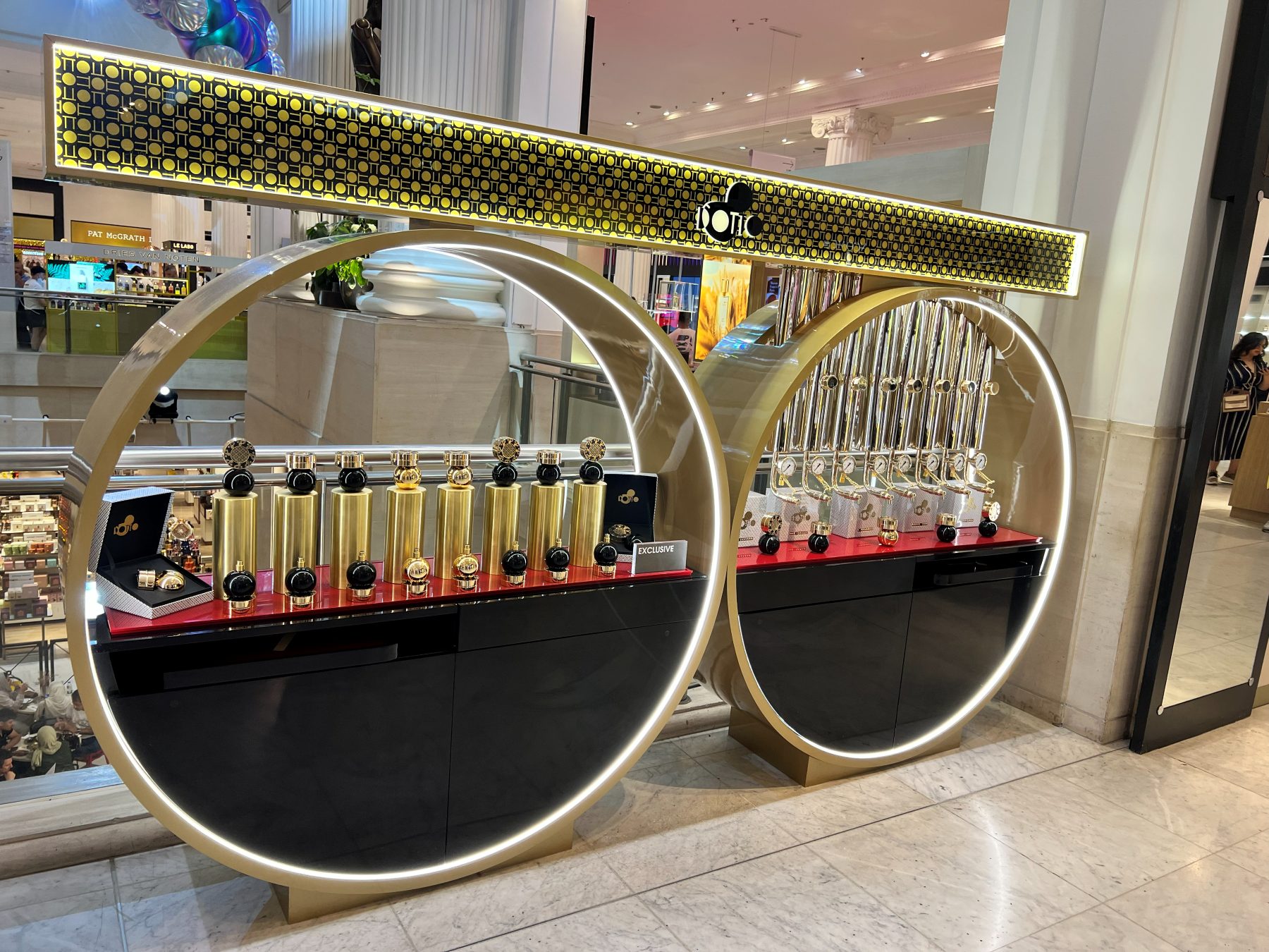 The completed D'Otto display at Selfridges, two illuminated gold rings with product shelving